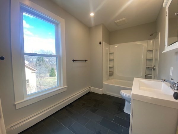 33 Ash Street Spencer, MA 01562 - Photo 26 of 37 a bathroom with a sink a large mirror and a bathtub