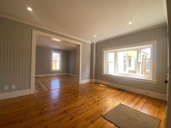 33 Ash Street Spencer, MA 01562 - Photo 4 of 37 a view of an empty room with wooden floor and a window