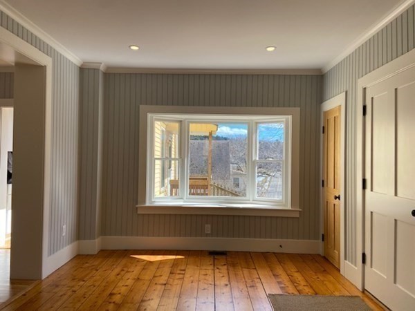 33 Ash Street Spencer, MA 01562 - Photo 8 of 37 a view of an empty room with wooden floor and a window