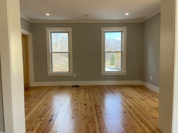 33 Ash Street Spencer, MA 01562 - Photo 9 of 37 an empty room with wooden floor and windows