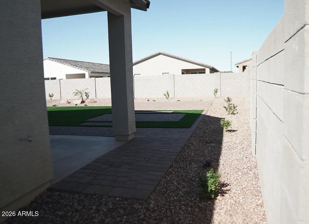 2426 Grenache Road San Tan Valley, AZ 85143 - Photo 12 of 29 a view of a back yard from a corridor