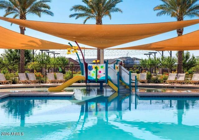 2426 Grenache Road San Tan Valley, AZ 85143 - Photo 20 of 29 a view of swimming pool with lawn chairs wooden floor and fence