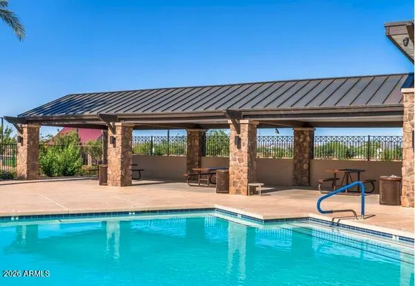 a swimming pool with outdoor seating and yard