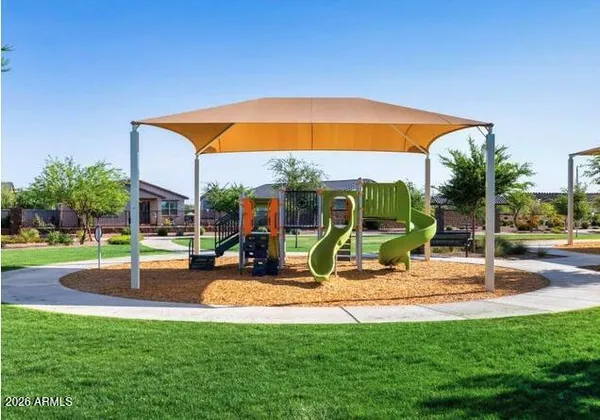 a view of backyard with swimming pool and seating space
