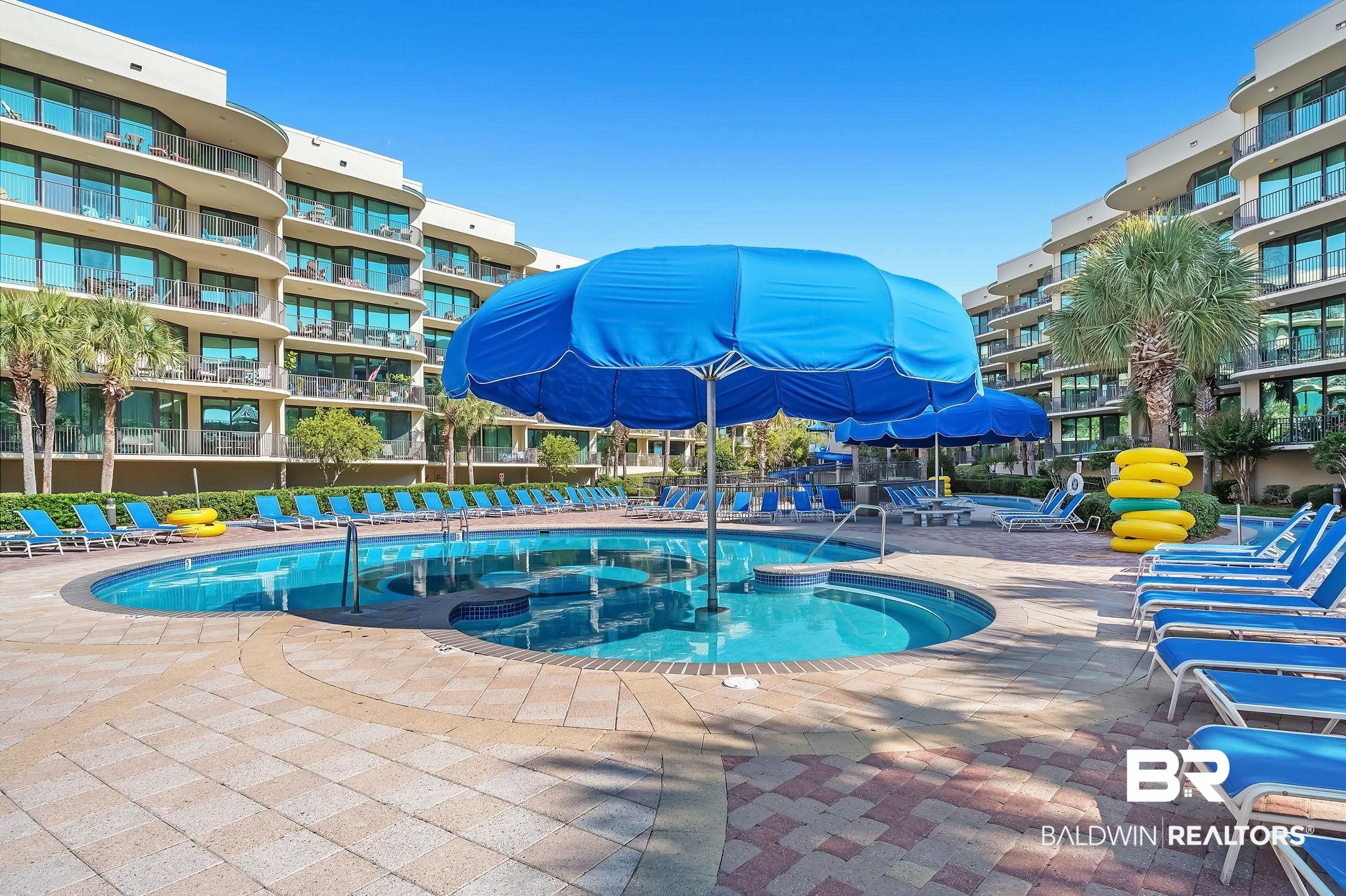 27580 Canal Road, Unit 1214 AND BOAT SLIP #62 Orange Beach, AL 36561 - Photo 56 of 67 Community pool with a patio