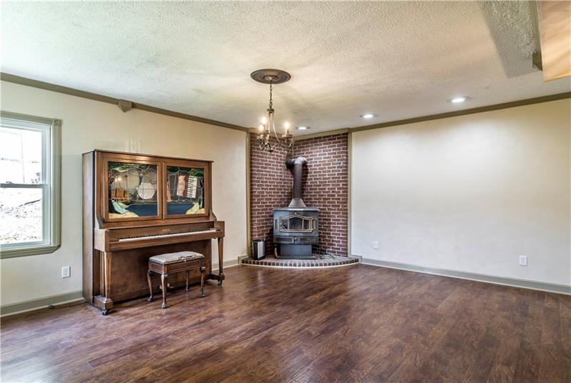 581 Arden Road Washington, PA 15301 - Photo 12 of 25 This dining room is large with lots of natural light. We LOVE the brick detail and the wood stove. It's classic and stunning.