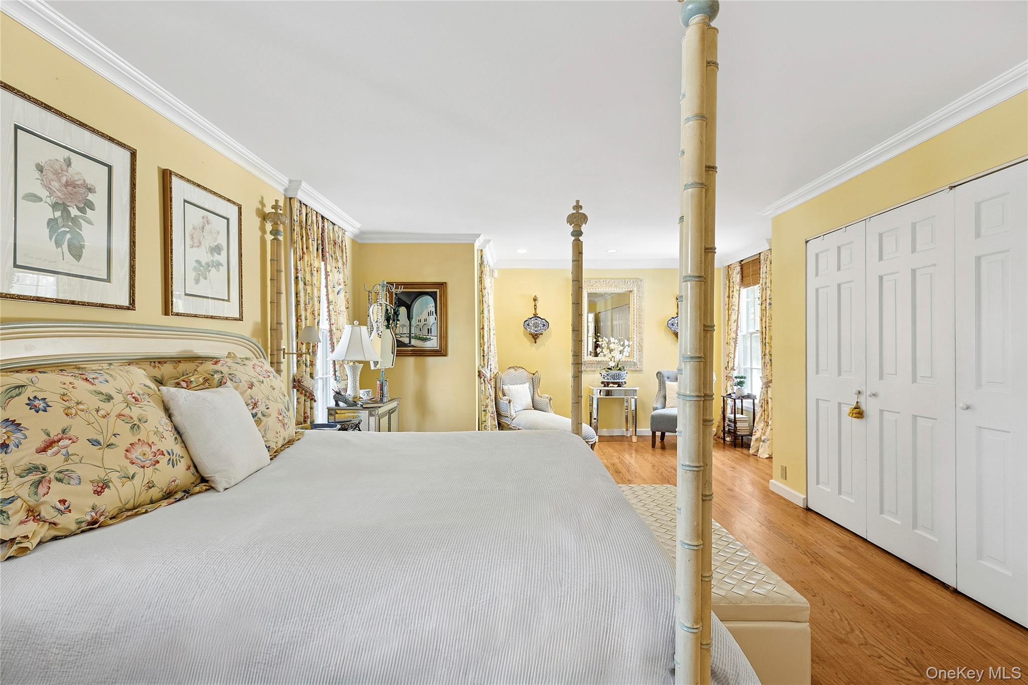 33 Bridgefield Road, Unit 2446 MAIN STREET Bridgehampton, NY 11932 - Photo 11 of 28 a spacious bedroom with a large bed and a chandelier