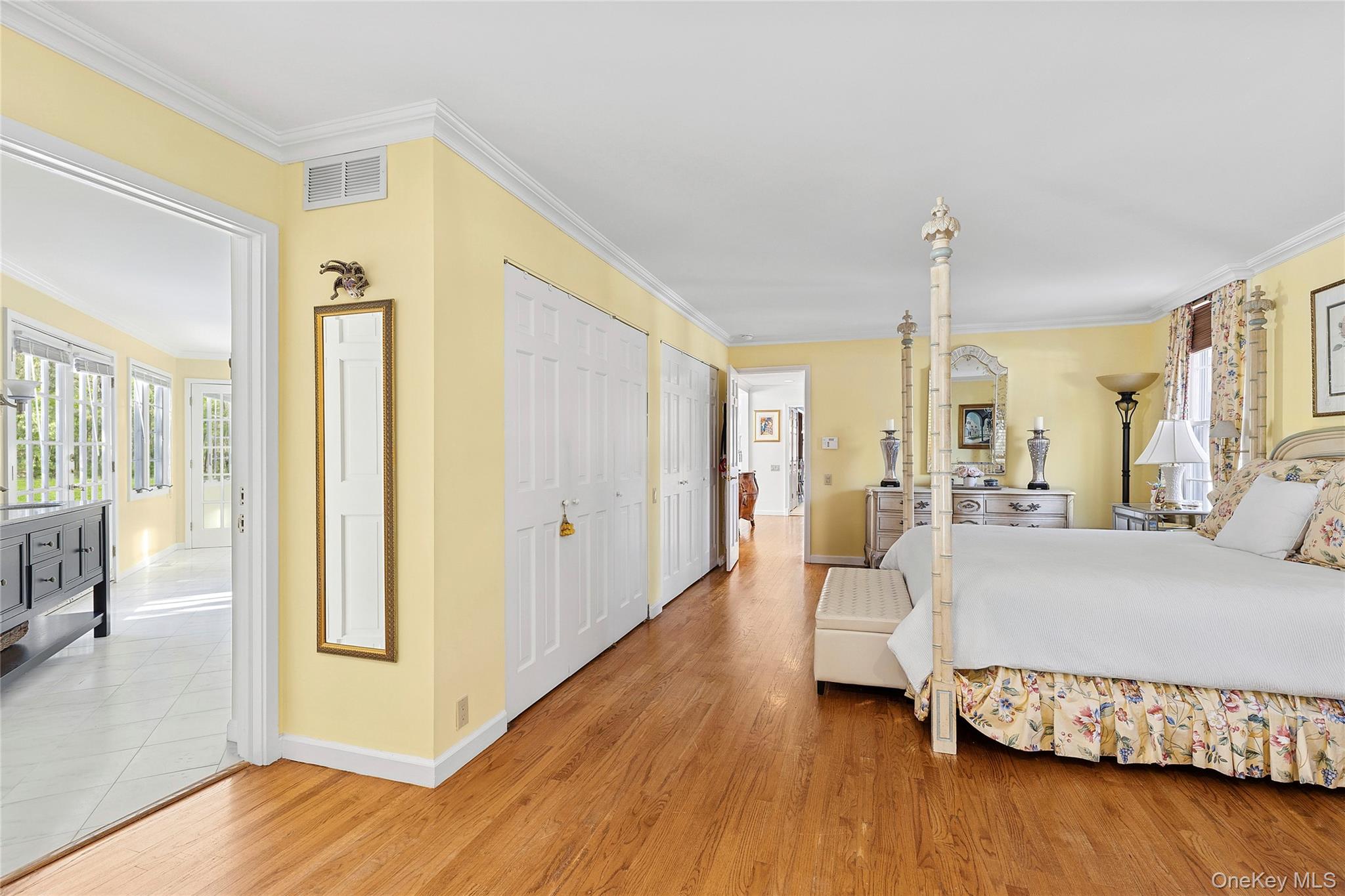 33 Bridgefield Road, Unit 2446 MAIN STREET Bridgehampton, NY 11932 - Photo 12 of 28 a bedroom with a bed and wooden floor