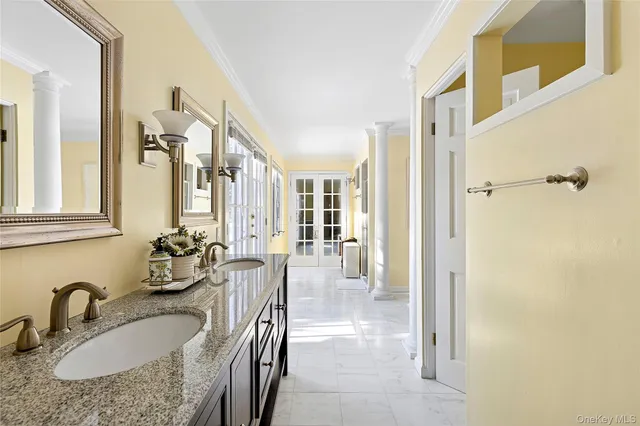 a bathroom with sinks granite countertop tub sink and mirror