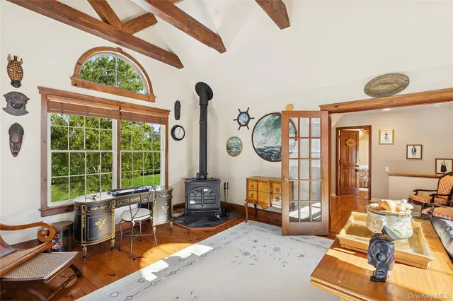 a living room with furniture a fireplace and a large window