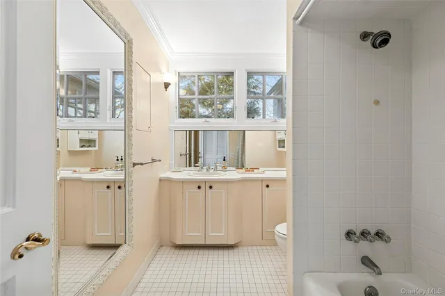 a bathroom with a granite countertop sink a toilet and shower
