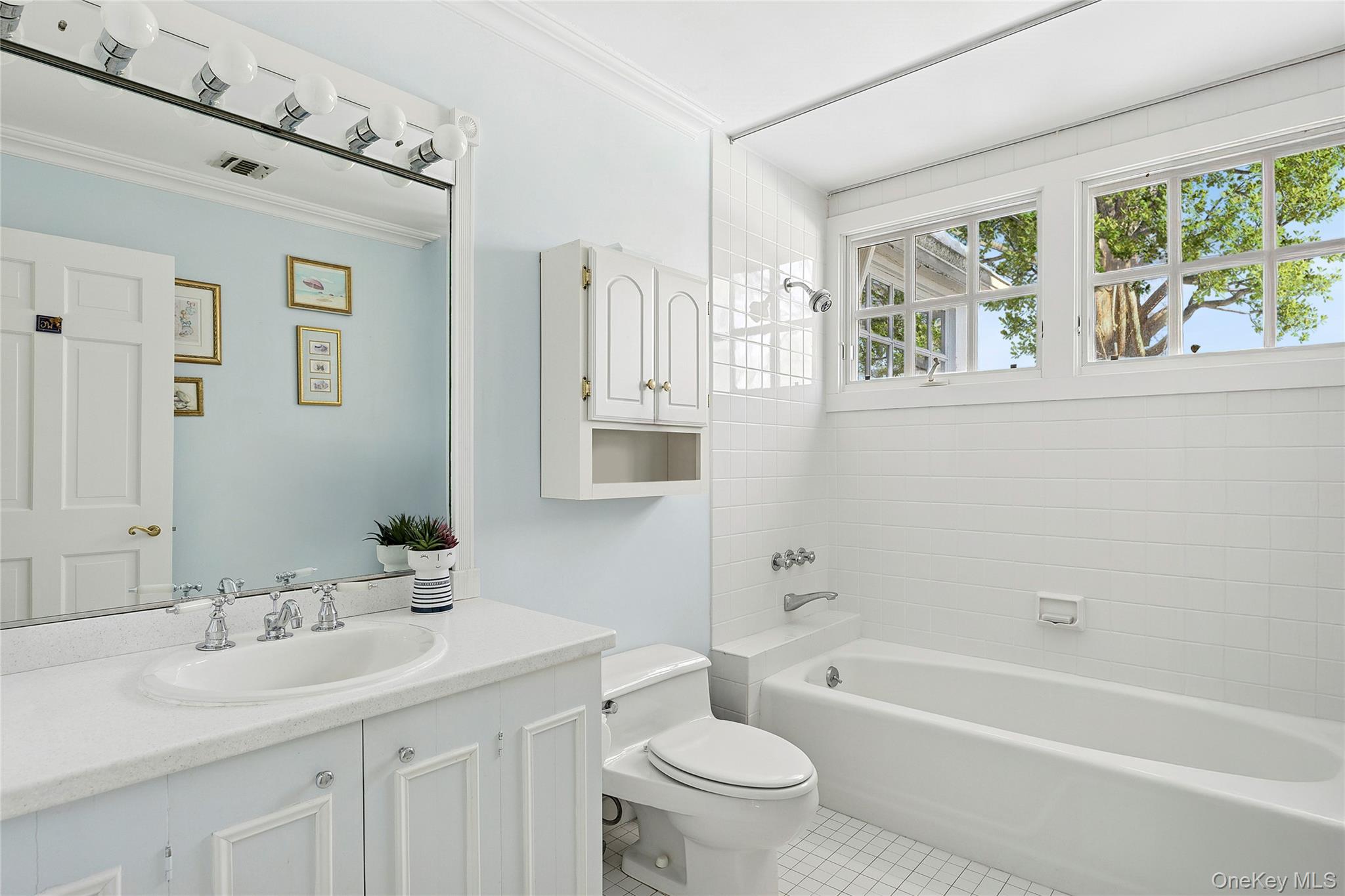 33 Bridgefield Road, Unit 2446 MAIN STREET Bridgehampton, NY 11932 - Photo 26 of 28 a bathroom with a toilet a sink a tub and a window