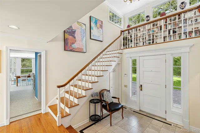 a view of entryway with wooden floor and windows
