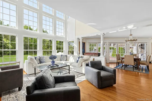 a living room with furniture and floor to ceiling windows