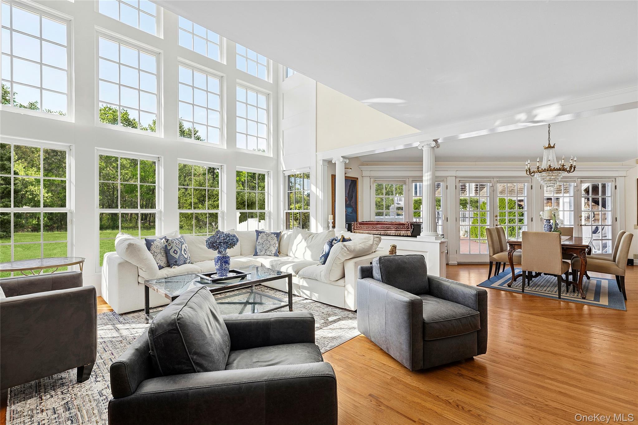 33 Bridgefield Road, Unit 2446 MAIN STREET Bridgehampton, NY 11932 - Photo 5 of 28 a living room with furniture and floor to ceiling windows