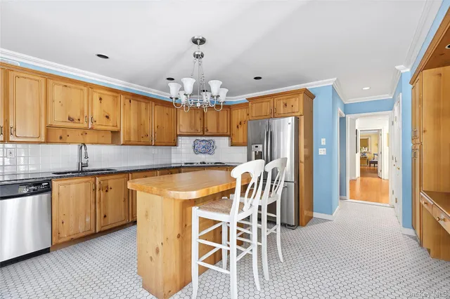 a kitchen with stainless steel appliances granite countertop a sink refrigerator and cabinets
