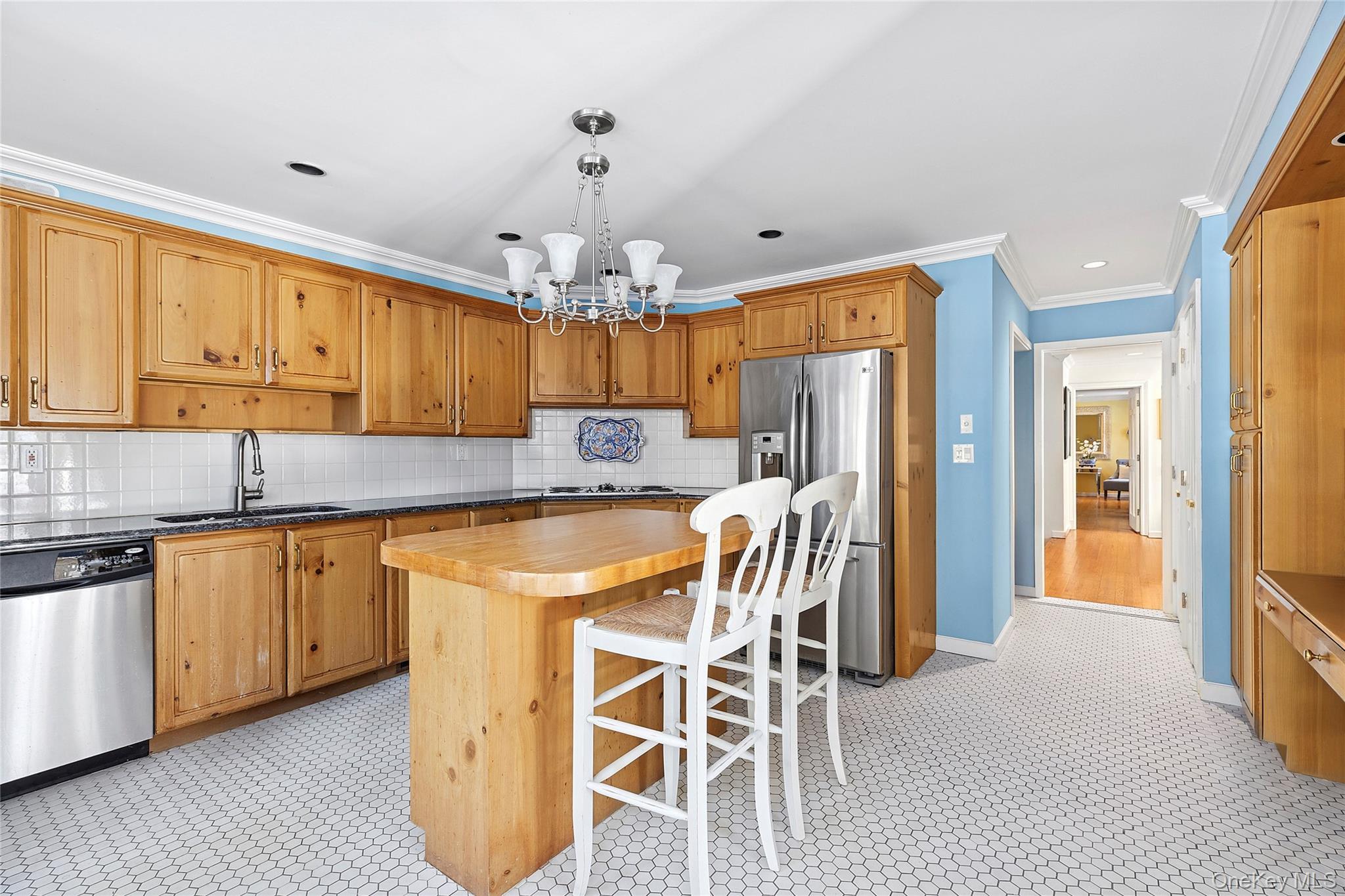 33 Bridgefield Road, Unit 2446 MAIN STREET Bridgehampton, NY 11932 - Photo 10 of 28 a kitchen with stainless steel appliances granite countertop a sink refrigerator and cabinets