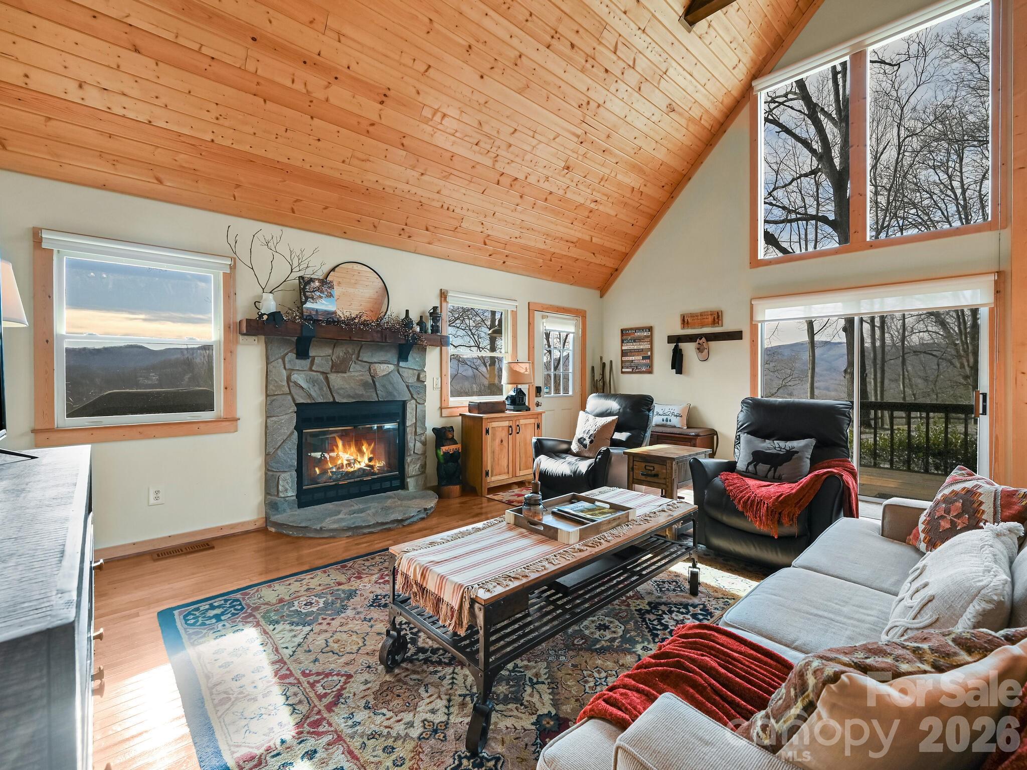 1954 Utah Mountain Road Waynesville, NC 28785 - Photo 13 of 36 a living room with furniture a fireplace and a large window