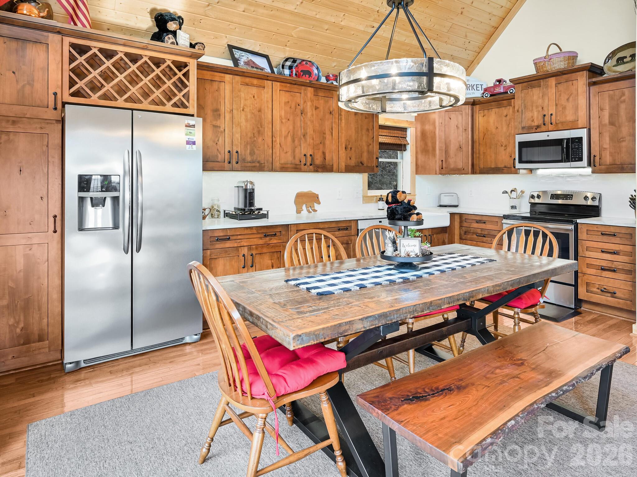 1954 Utah Mountain Road Waynesville, NC 28785 - Photo 15 of 36 a kitchen with stainless steel appliances granite countertop a stove top oven a refrigerator and dinning table