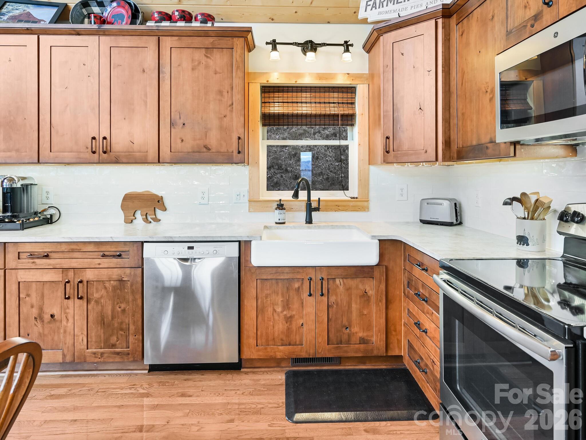 1954 Utah Mountain Road Waynesville, NC 28785 - Photo 17 of 36 a kitchen with stainless steel appliances granite countertop a stove a sink and a microwave