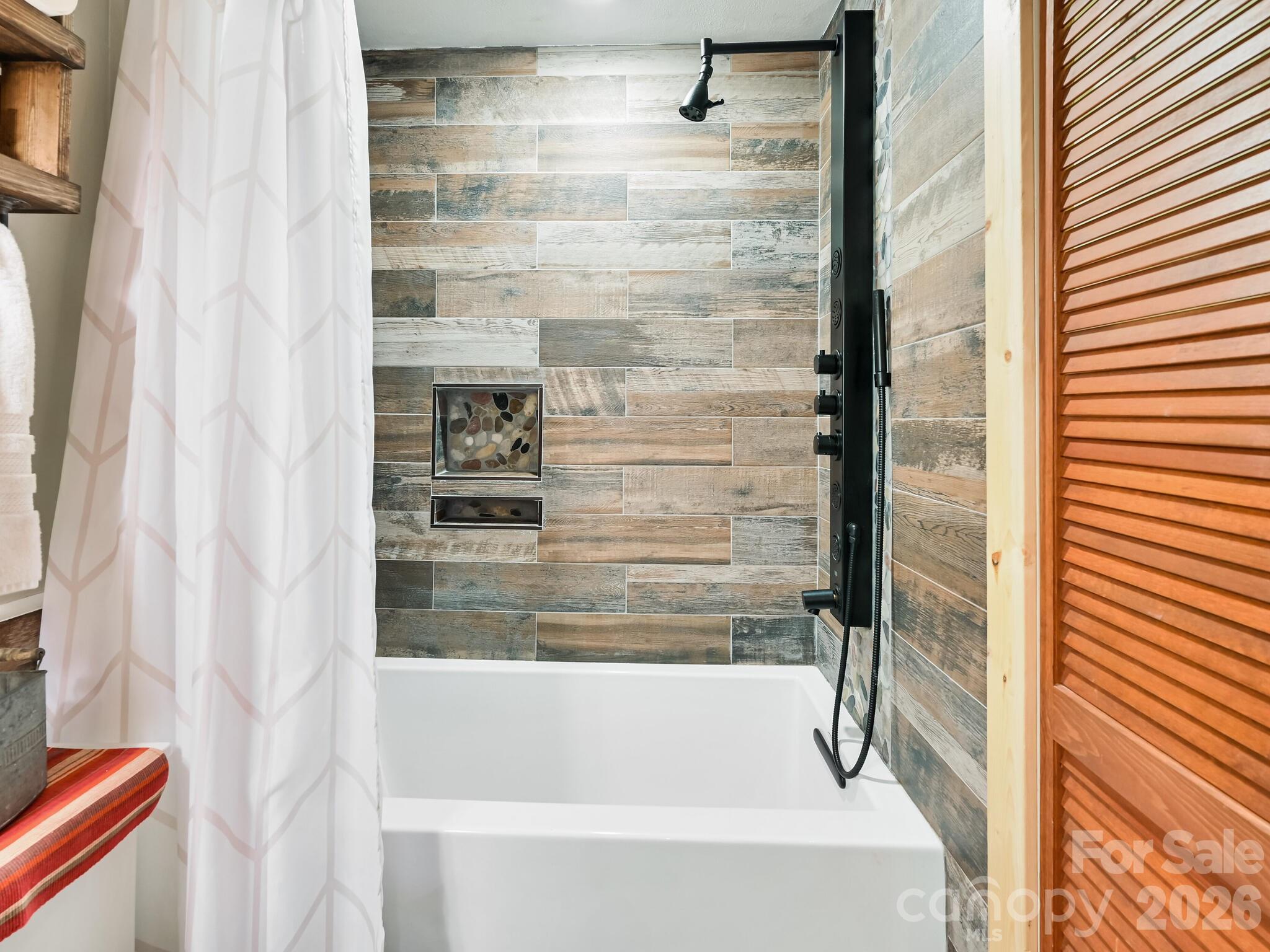 1954 Utah Mountain Road Waynesville, NC 28785 - Photo 23 of 36 a bathroom with bathtub and shower