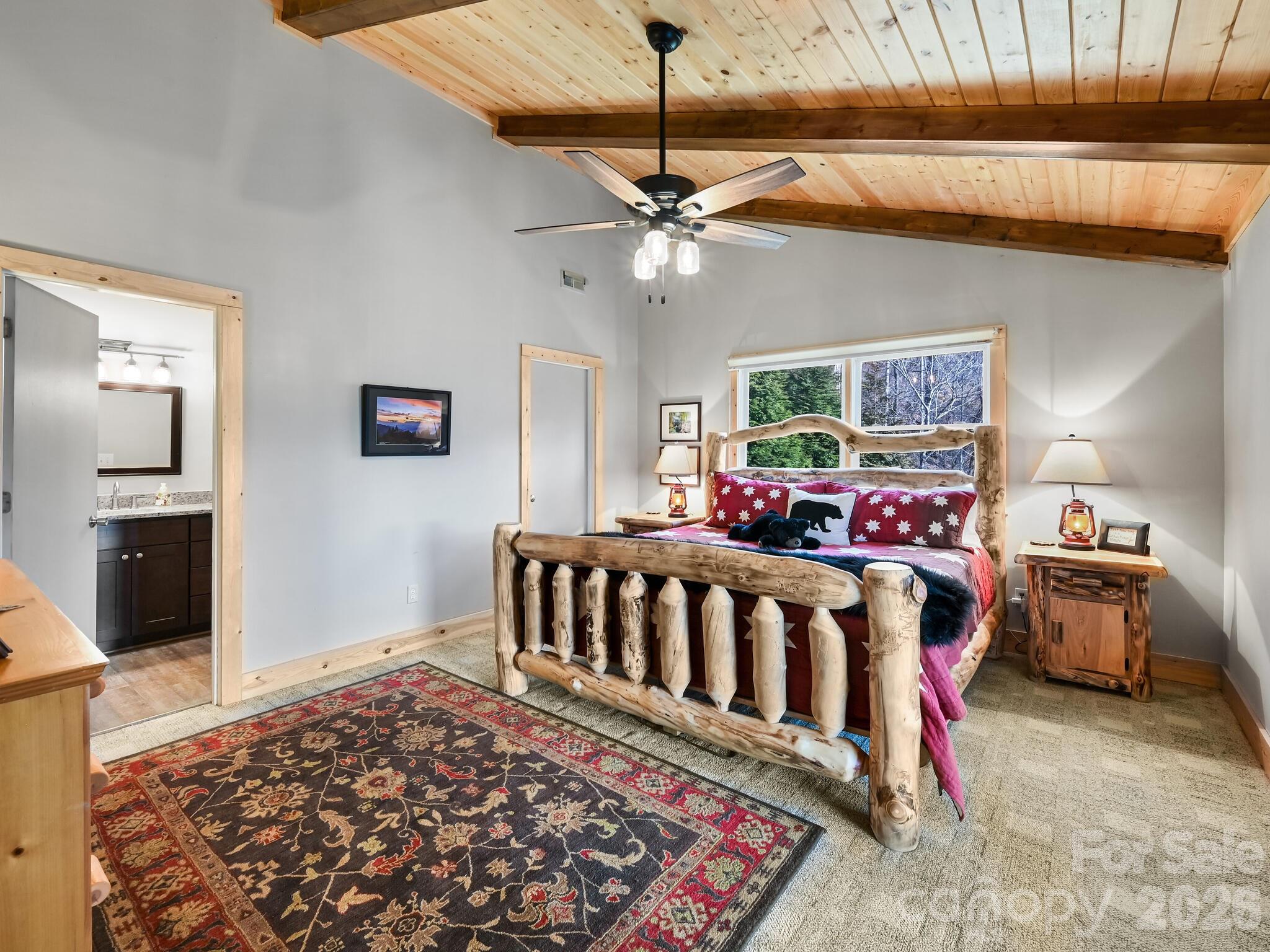1954 Utah Mountain Road Waynesville, NC 28785 - Photo 26 of 36 a bedroom with furniture and a chandelier