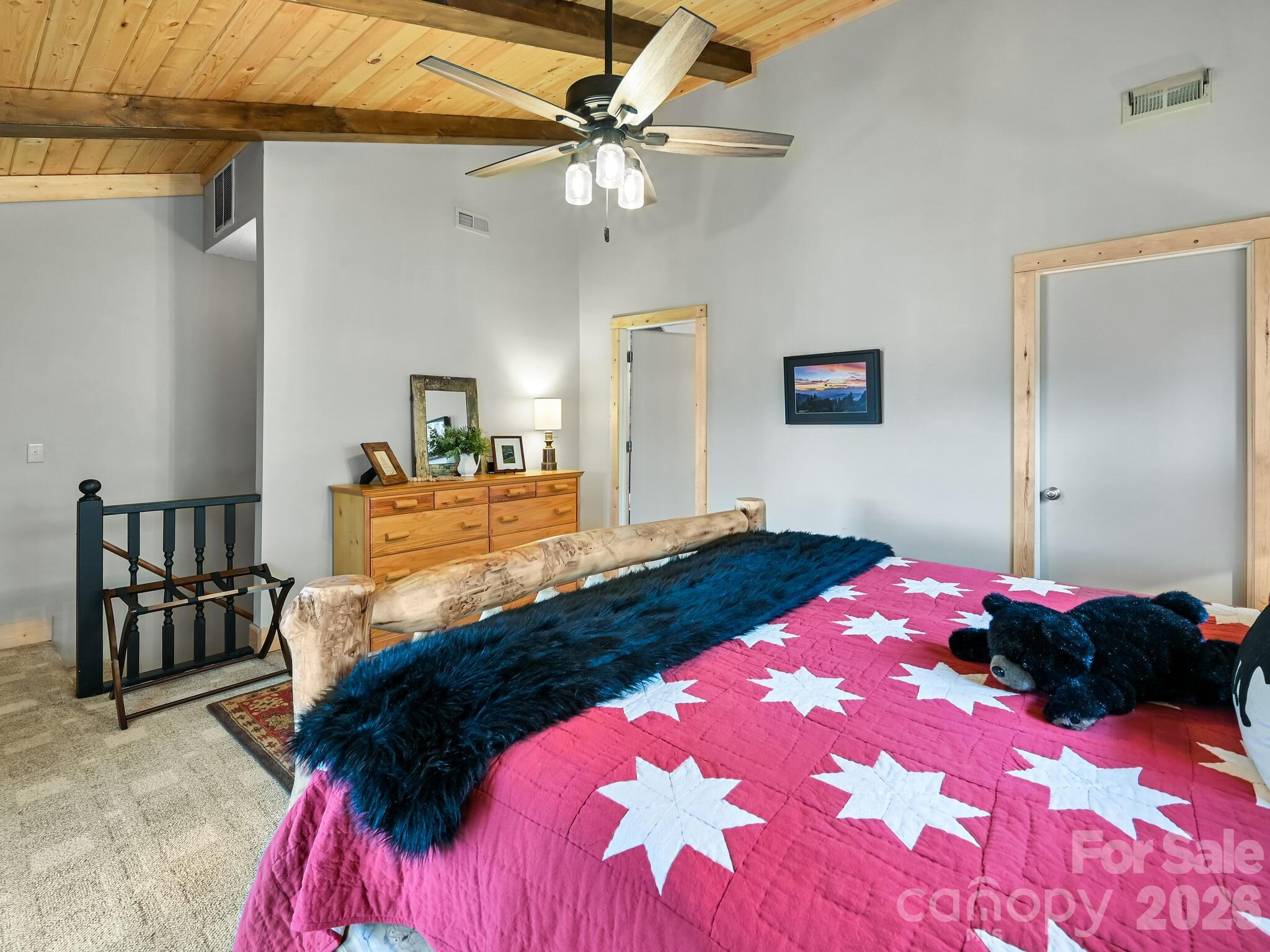 1954 Utah Mountain Road Waynesville, NC 28785 - Photo 27 of 36 a bedroom with a bed and a chandelier