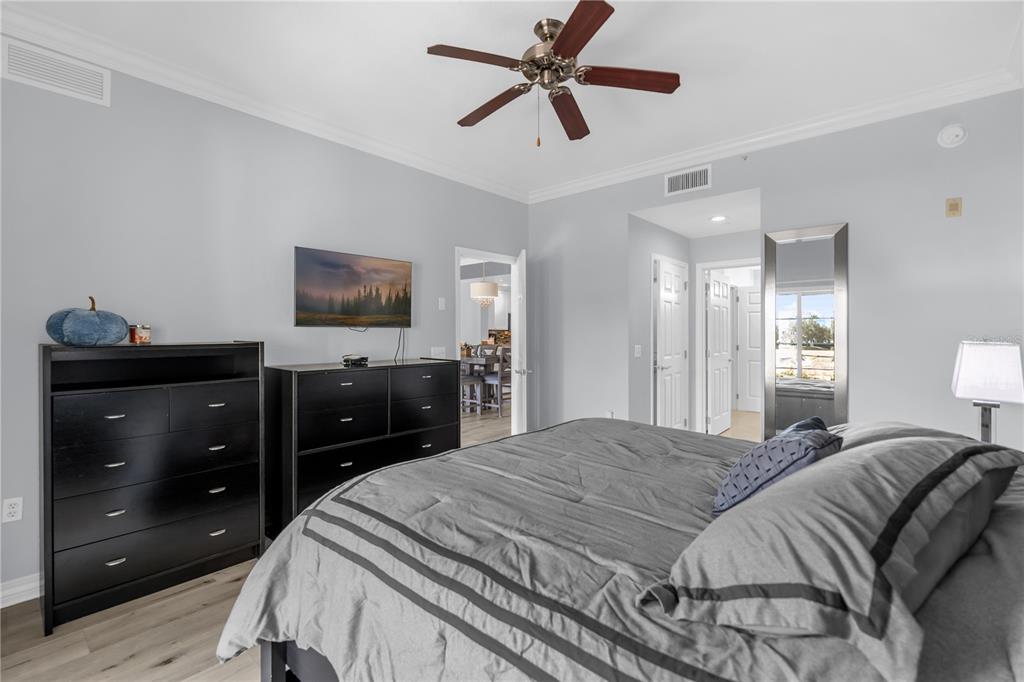 7618 Sandy Ridge Drive, Unit 103 Reunion, FL 34747 - Photo 11 of 37 a bedroom with a bed and a dresser