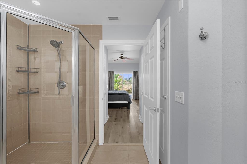 7618 Sandy Ridge Drive, Unit 103 Reunion, FL 34747 - Photo 13 of 37 a view of a hallway with large glass door and shower