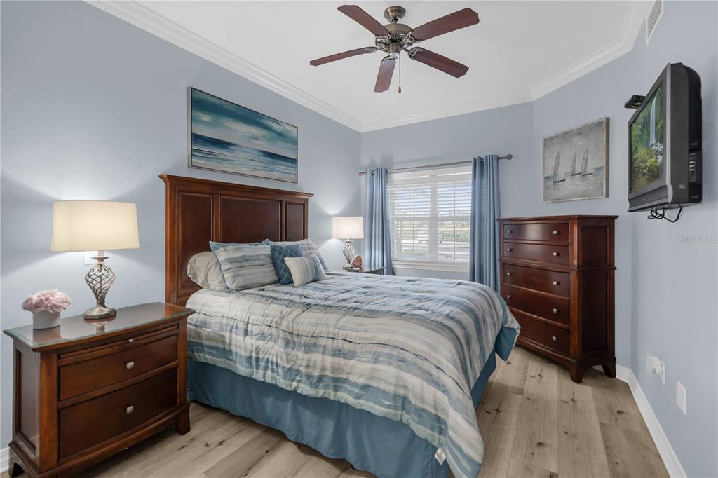 7618 Sandy Ridge Drive, Unit 103 Reunion, FL 34747 - Photo 18 of 37 a bedroom with a bed and wooden floor