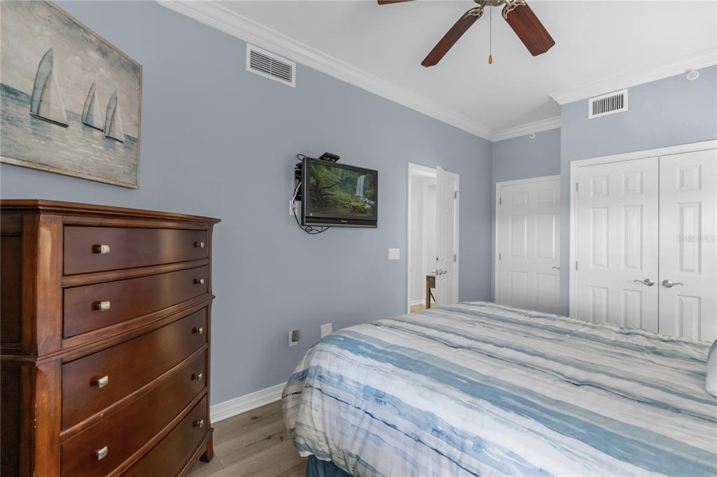 7618 Sandy Ridge Drive, Unit 103 Reunion, FL 34747 - Photo 19 of 37 a bedroom with a bed and a chandelier