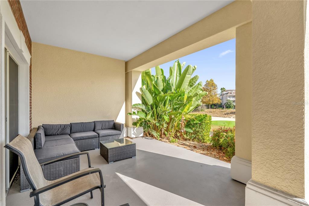 7618 Sandy Ridge Drive, Unit 103 Reunion, FL 34747 - Photo 22 of 37 a living room with furniture and a large window