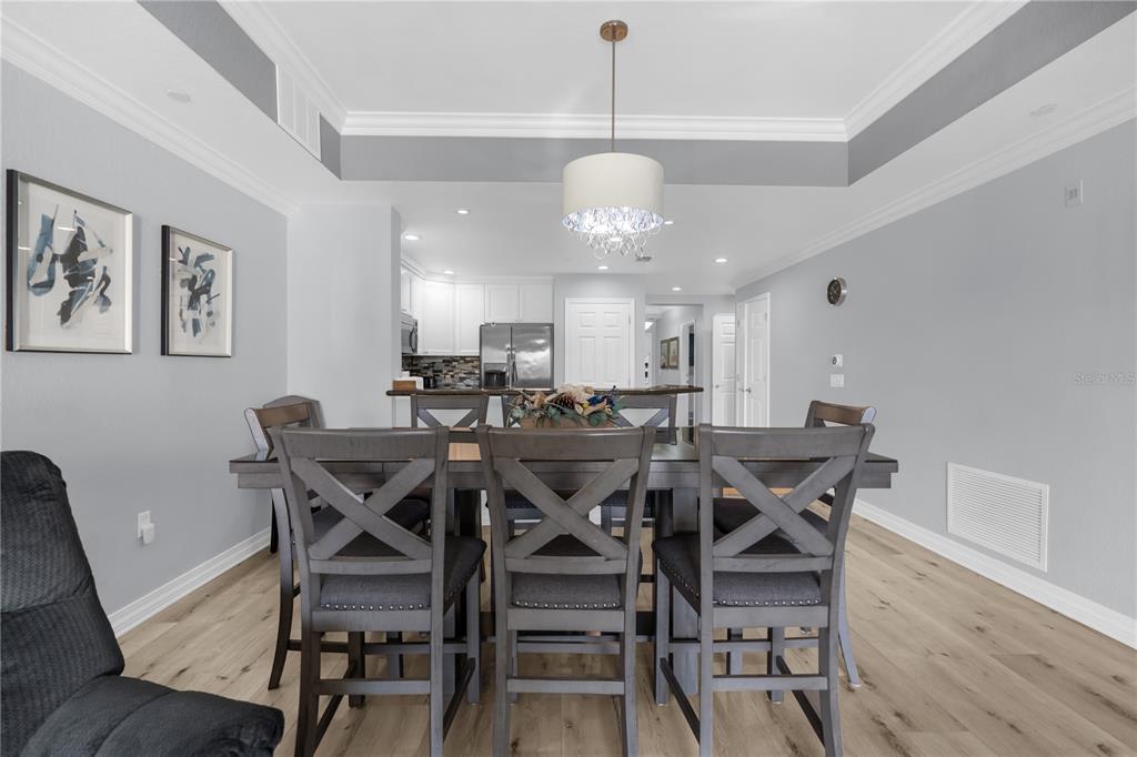 7618 Sandy Ridge Drive, Unit 103 Reunion, FL 34747 - Photo 7 of 37 a view of a dining room with furniture and wooden floor