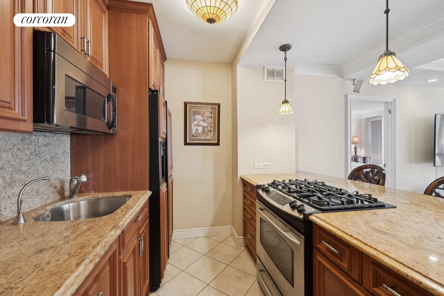 150 East 85th Street, Unit 8ABC Manhattan, NY 10028 - Photo 5 of 12 a kitchen that has a sink stainless steel appliances and cabinets