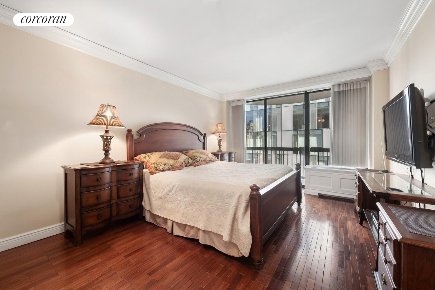 150 East 85th Street, Unit 8ABC Manhattan, NY 10028 - Photo 7 of 12 a bedroom with a bed and a flat tv screen on a dresser