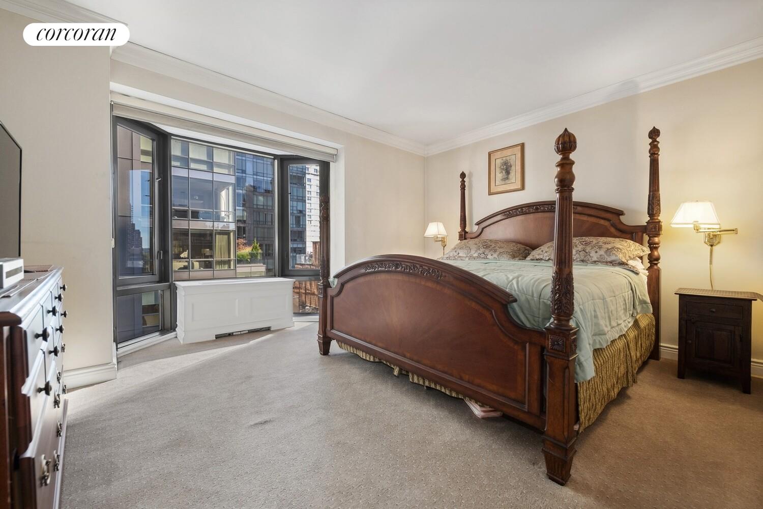 150 East 85th Street, Unit 8ABC Manhattan, NY 10028 - Photo 8 of 12 a bedroom with a bed lamp and a large window