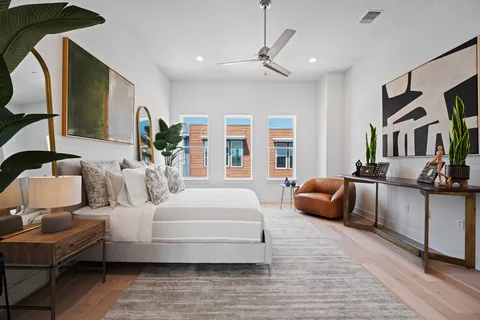 a bedroom with furniture and a large window