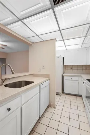 a kitchen with a stove sink and cabinets