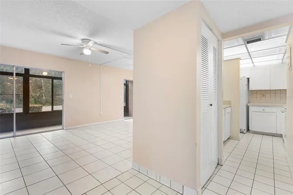 a bedroom with a bed and a chandelier fan