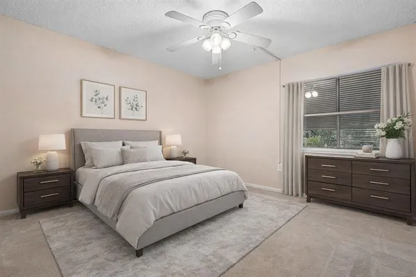 an empty room with a window and a fan