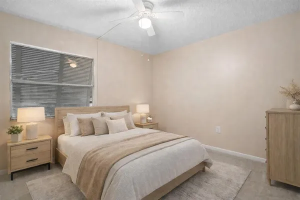 en empty room with windows and ceiling fan
