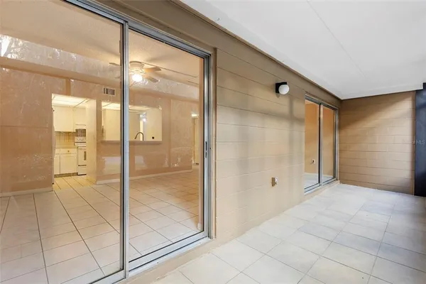 a view of a porch with a floor to ceiling window next to a yard