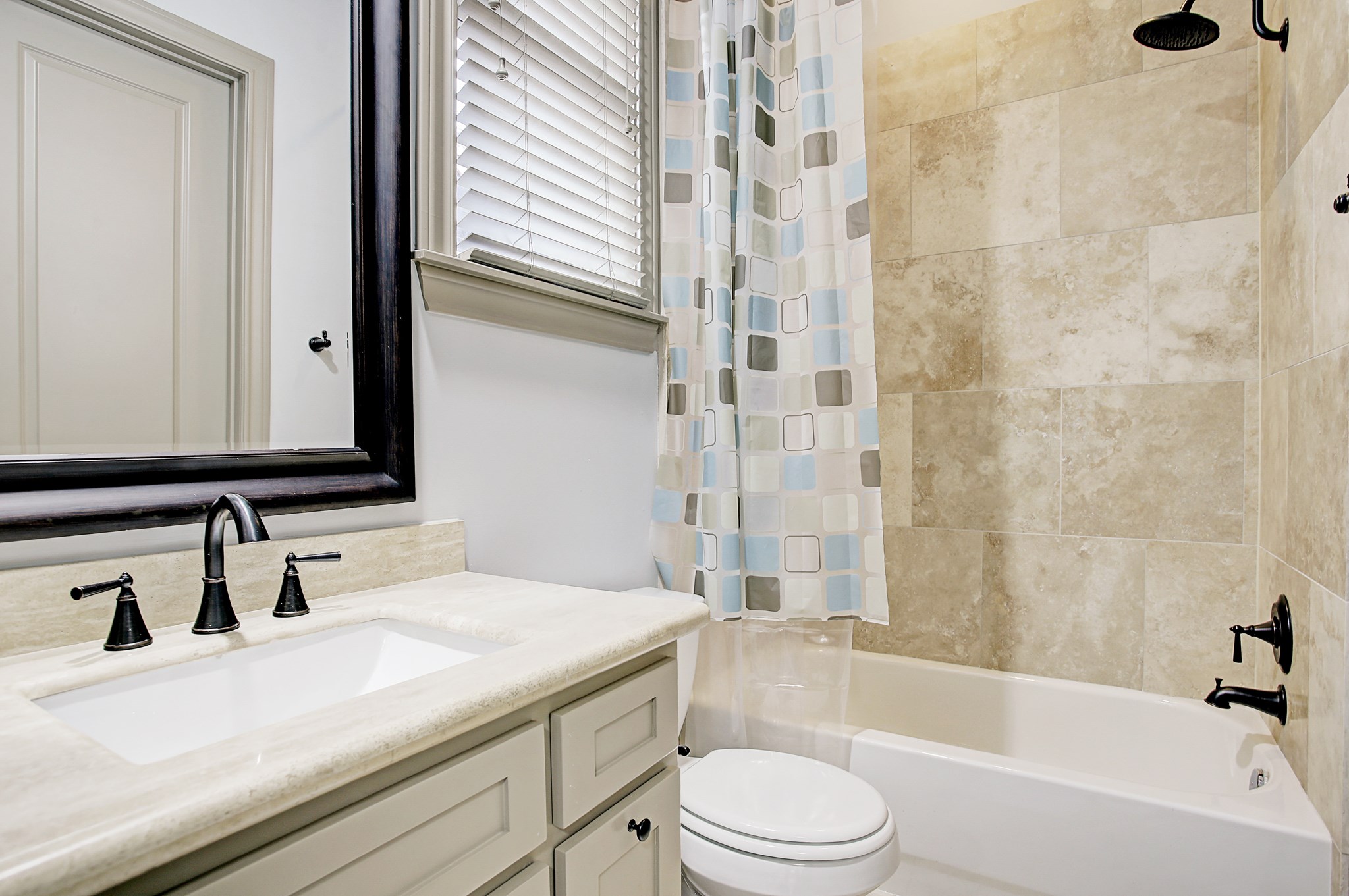 1307 Rosedale Street Houston, TX 77004 - Photo 21 of 32 a bathroom with a granite countertop bathtub sink vanity mirror and toilet