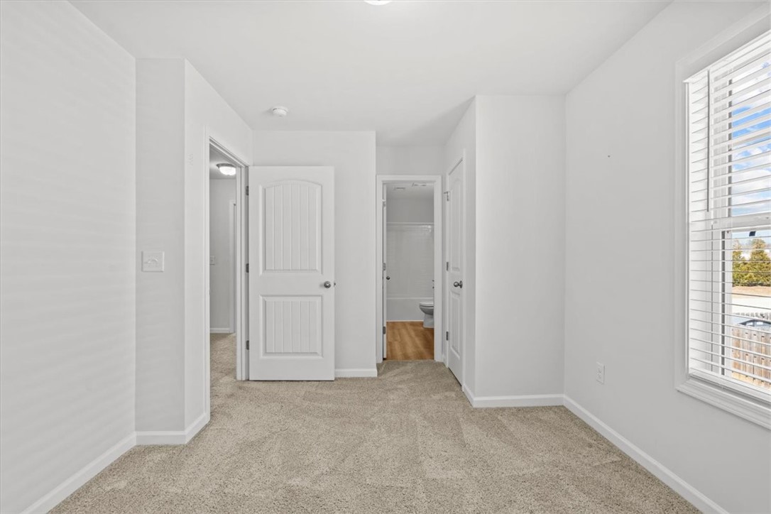 118 Adger Road Pendleton, SC 29670 - Photo 16 of 31 This bright and airy room features soft carpeting and ample natural light, creating a serene personal retreat.