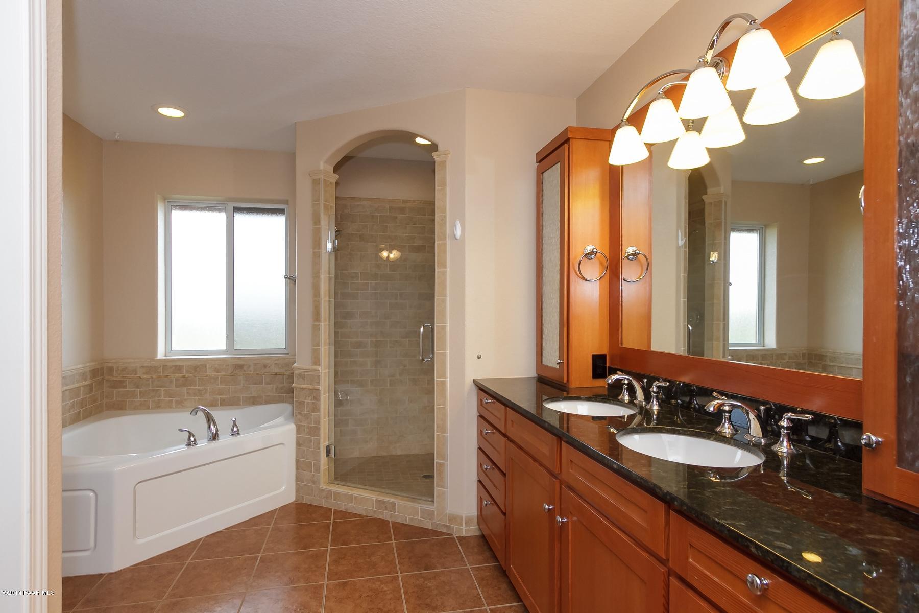 1380 East Valley View Road Prescott, AZ 86303 - Photo 22 of 36 a bathroom with a granite countertop sink mirror and bathtub