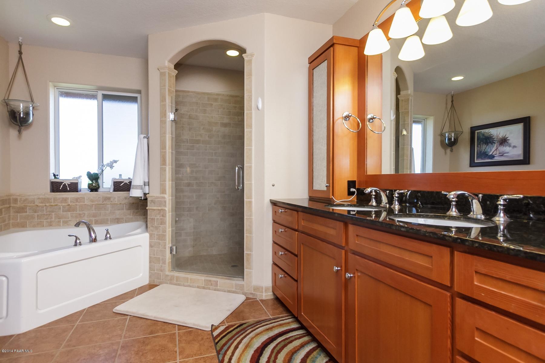 1380 East Valley View Road Prescott, AZ 86303 - Photo 23 of 36 a bathroom with a sink a large mirror and a bathtub