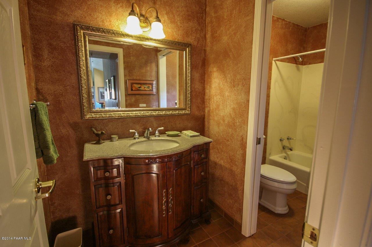 1380 East Valley View Road Prescott, AZ 86303 - Photo 26 of 36 a bathroom with a granite countertop sink toilet and shower