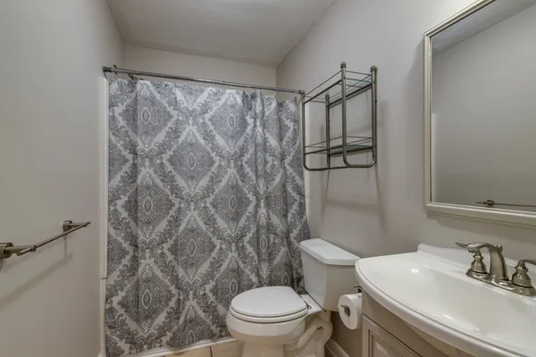 a bathroom with a toilet sink and shower