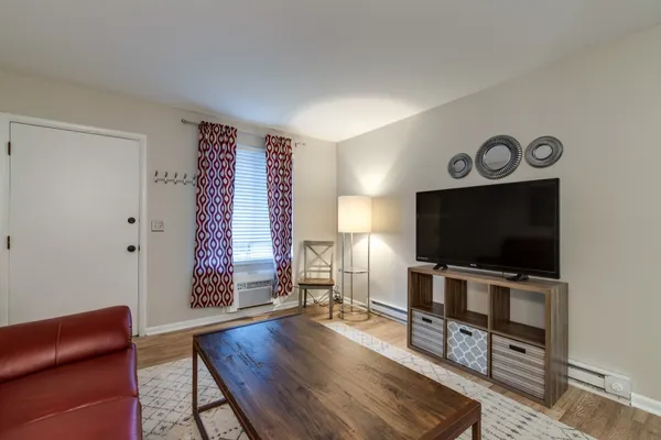 a living room with furniture and a flat screen tv