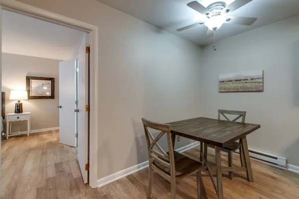 a view of a dining room with furniture and wooden floor